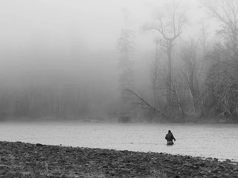 Dr. George Pess fly fishing on a misty Pacific Northwest river